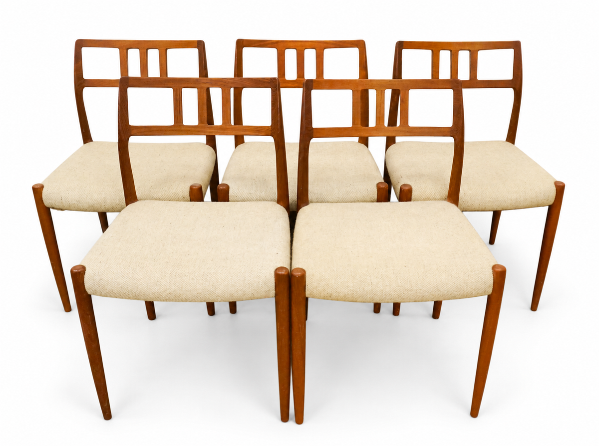 Set of five teak dining chairs with pale upholstered seats, cataloged as Niels Otto Møller