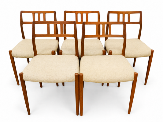 Set of five teak dining chairs with pale upholstered seats, cataloged as Niels Otto Møller