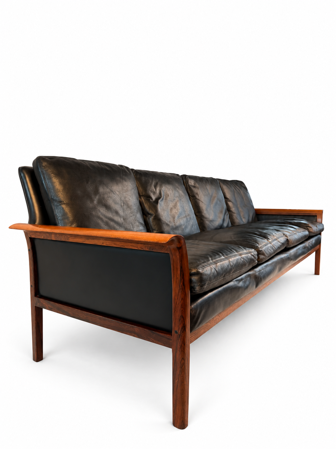 Side view of the rosewood sofa with black leather cushions