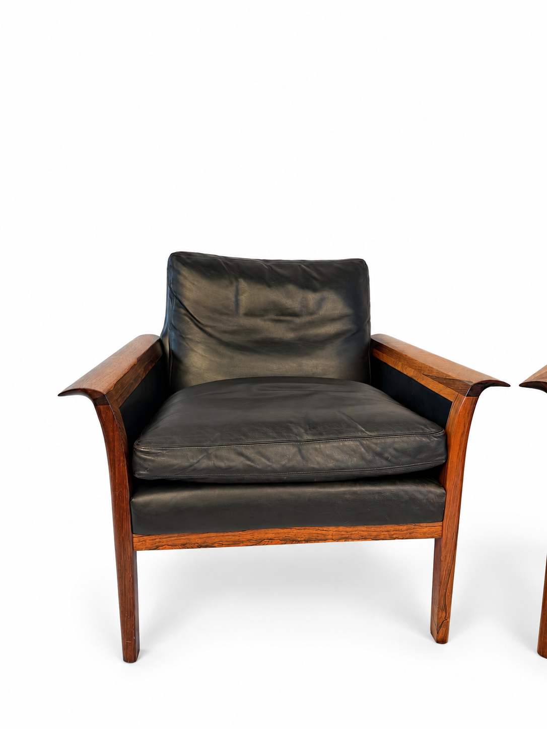 Individual rosewood lounge chair with black leather cushions and curved wooden arms