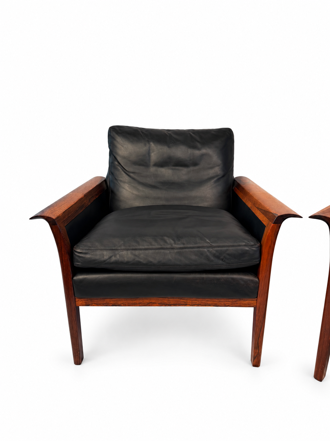 Second rosewood lounge chair with black leather cushions, full view