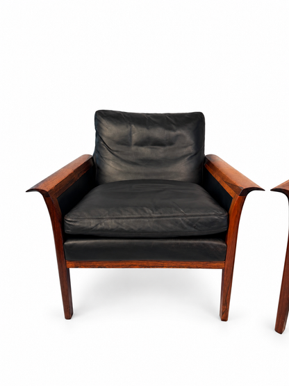 Second rosewood lounge chair with black leather cushions, full view