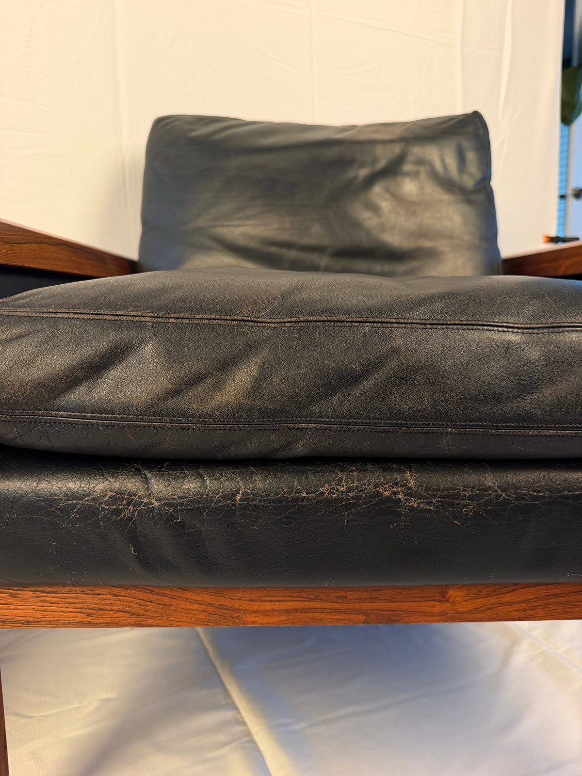 Original closeup of creasing and worn leather on a lounge chair