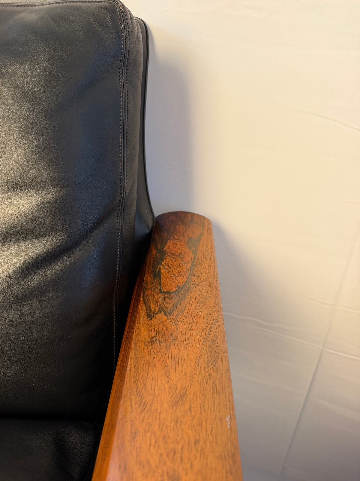 Original detail of surface wear on a rosewood lounge chair arm