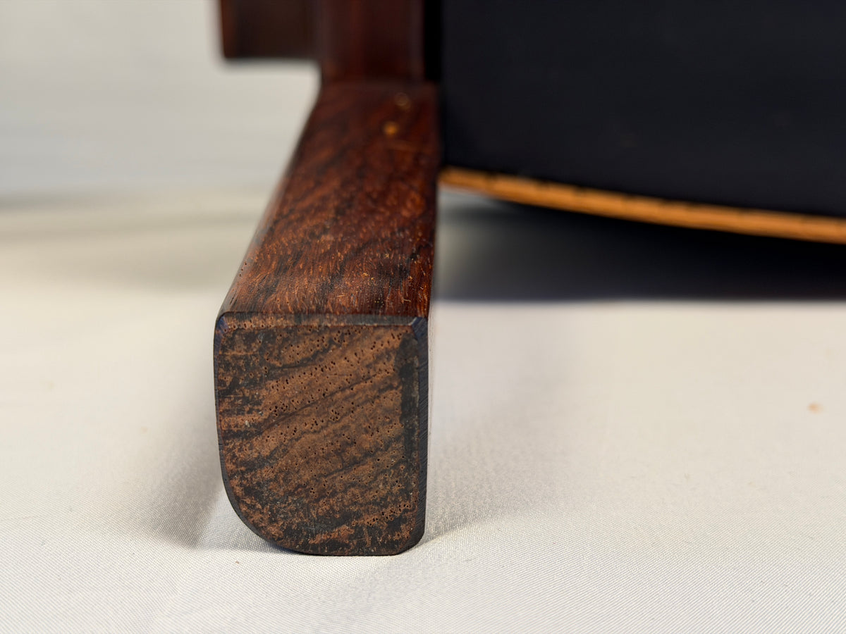 Original detail of wear on a rosewood lounge chair leg and foot