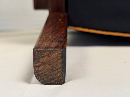 Original detail of wear on a rosewood lounge chair leg and foot