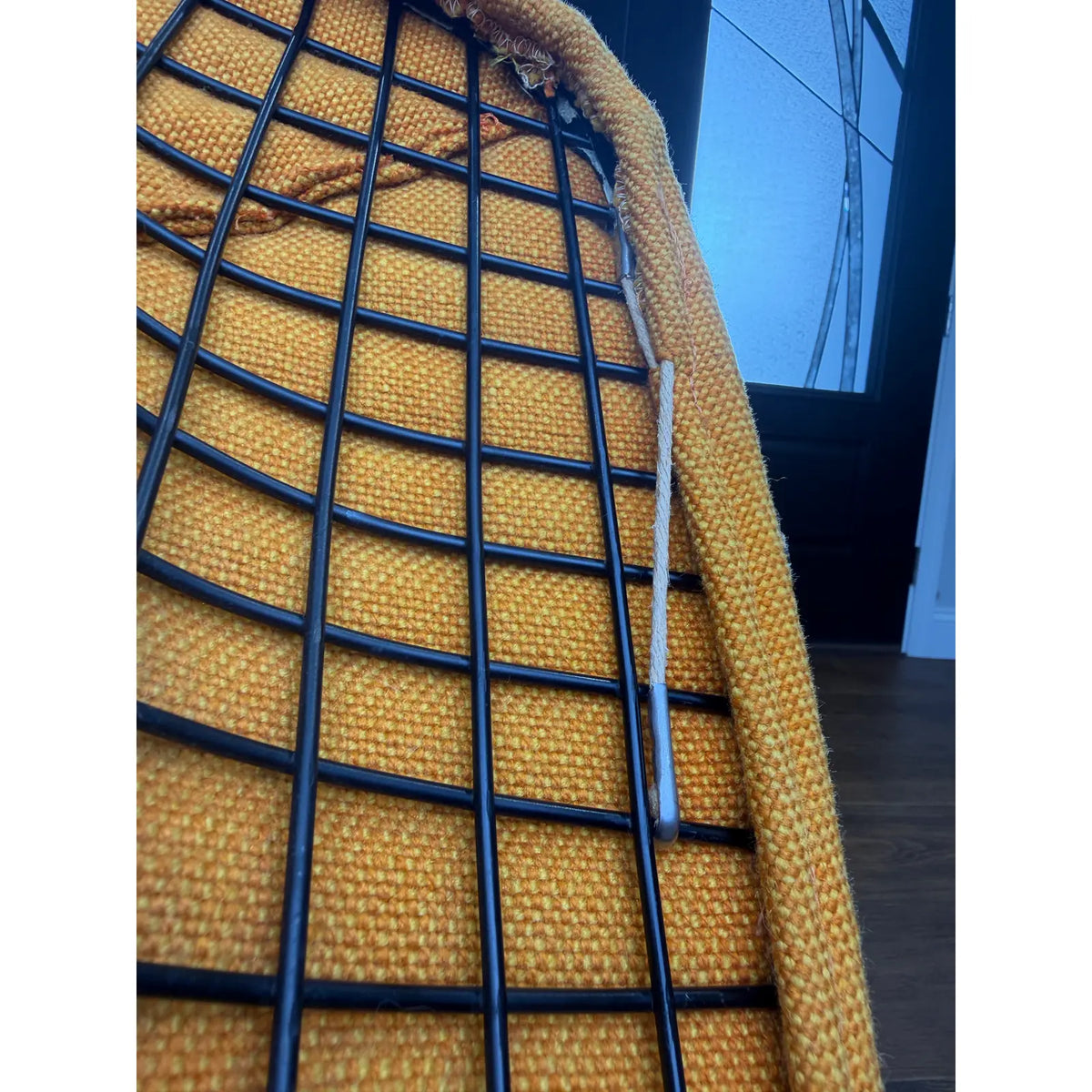 Mustard-upholstered Diamond lounge chair, close view of wire shell and upholstery edging