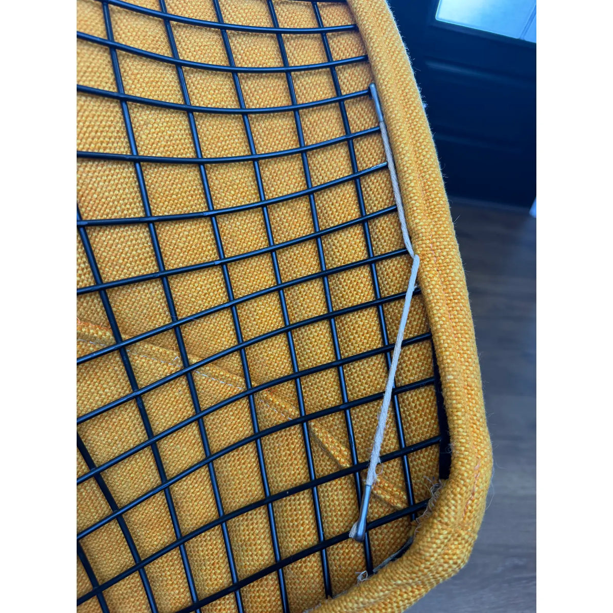 Mustard-upholstered Diamond lounge chair, upholstery edge and wire shell detail