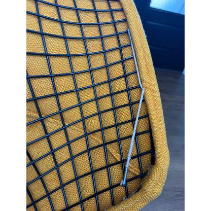 Mustard-upholstered Diamond lounge chair, upholstery edge and wire shell detail