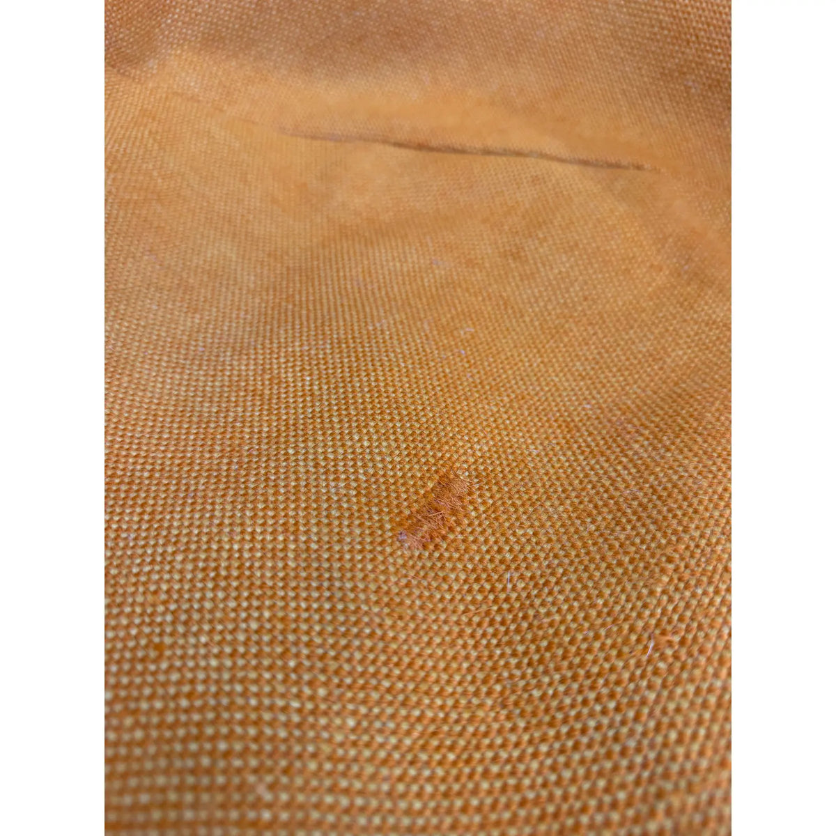 Mustard-upholstered Diamond lounge chair, seat upholstery wear and repair detail
