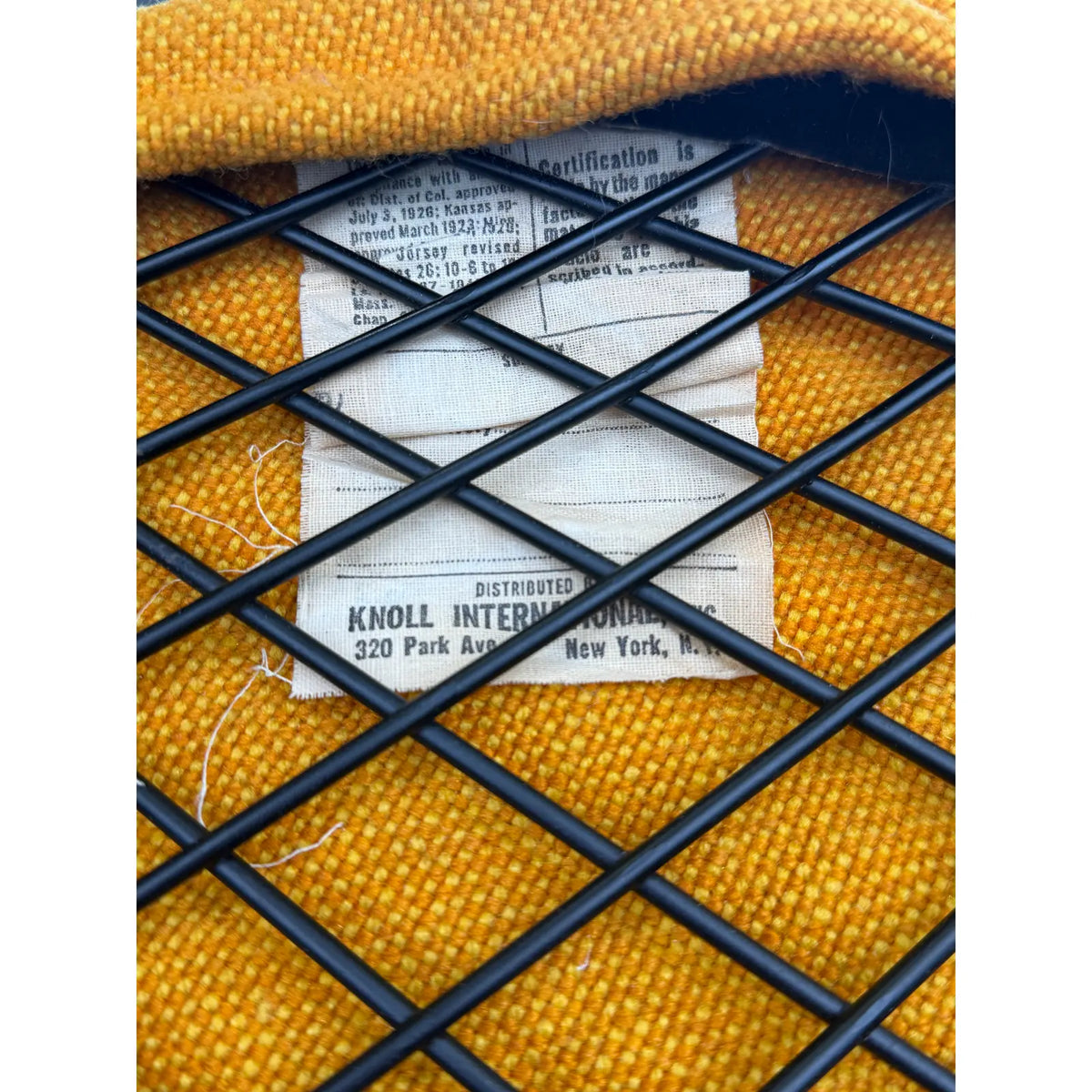 Mustard-upholstered Diamond lounge chair, Knoll International distributor label beneath the wire frame
