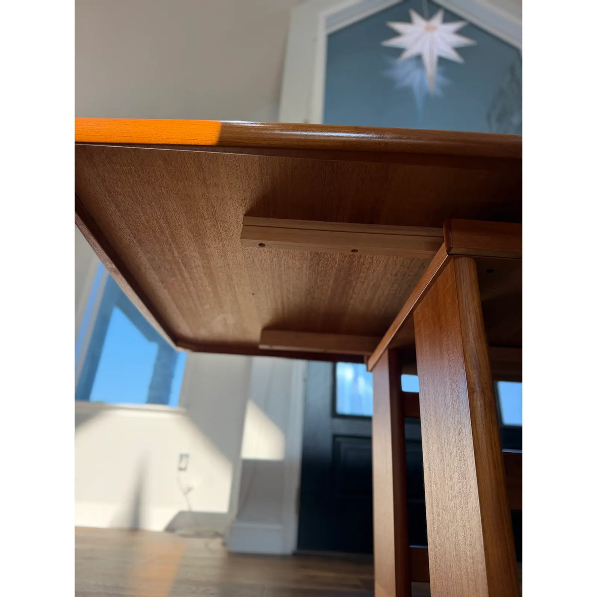 Teak expanding dining table, underside of the tabletop and supporting frame