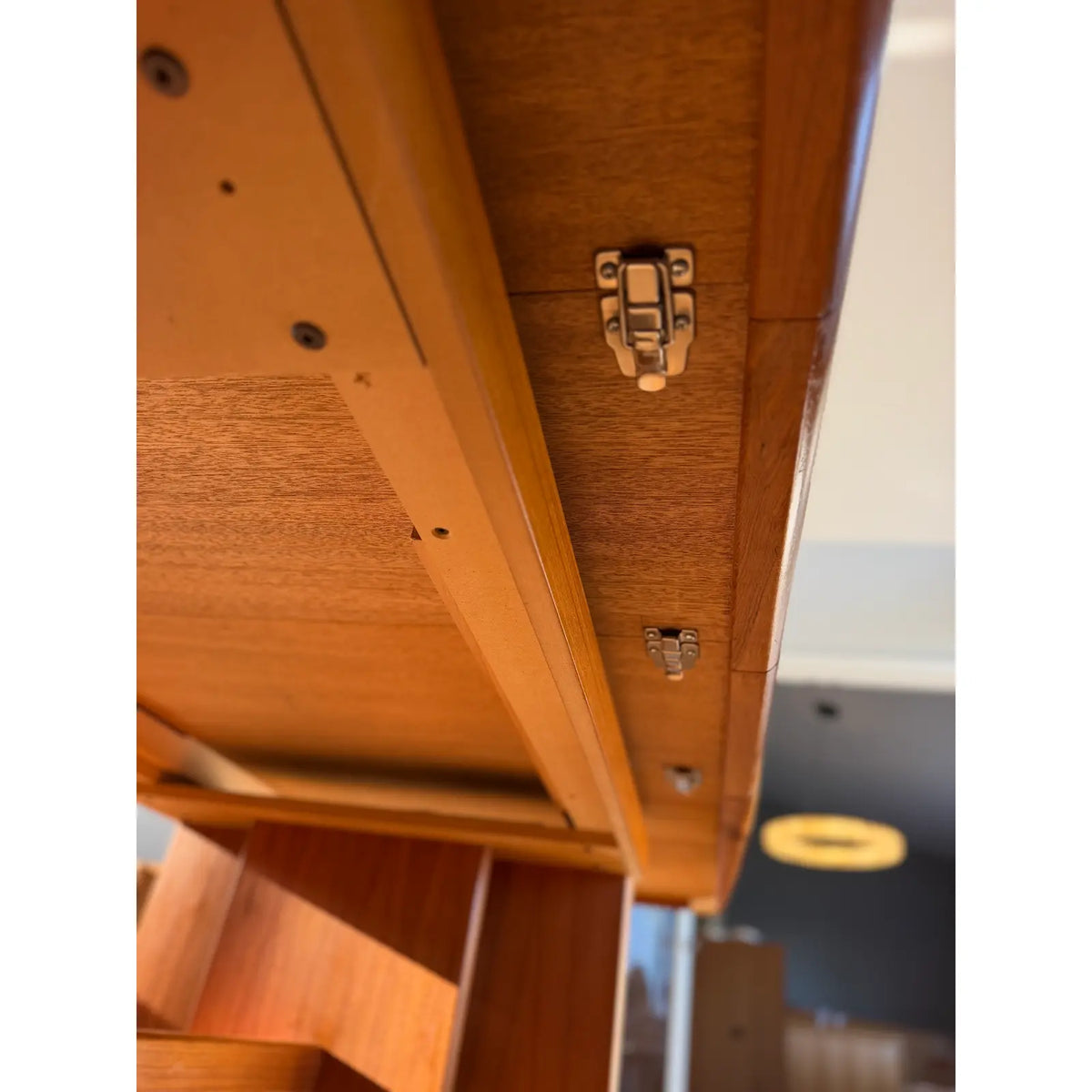 Teak expanding dining table, underside with closing latch and rails