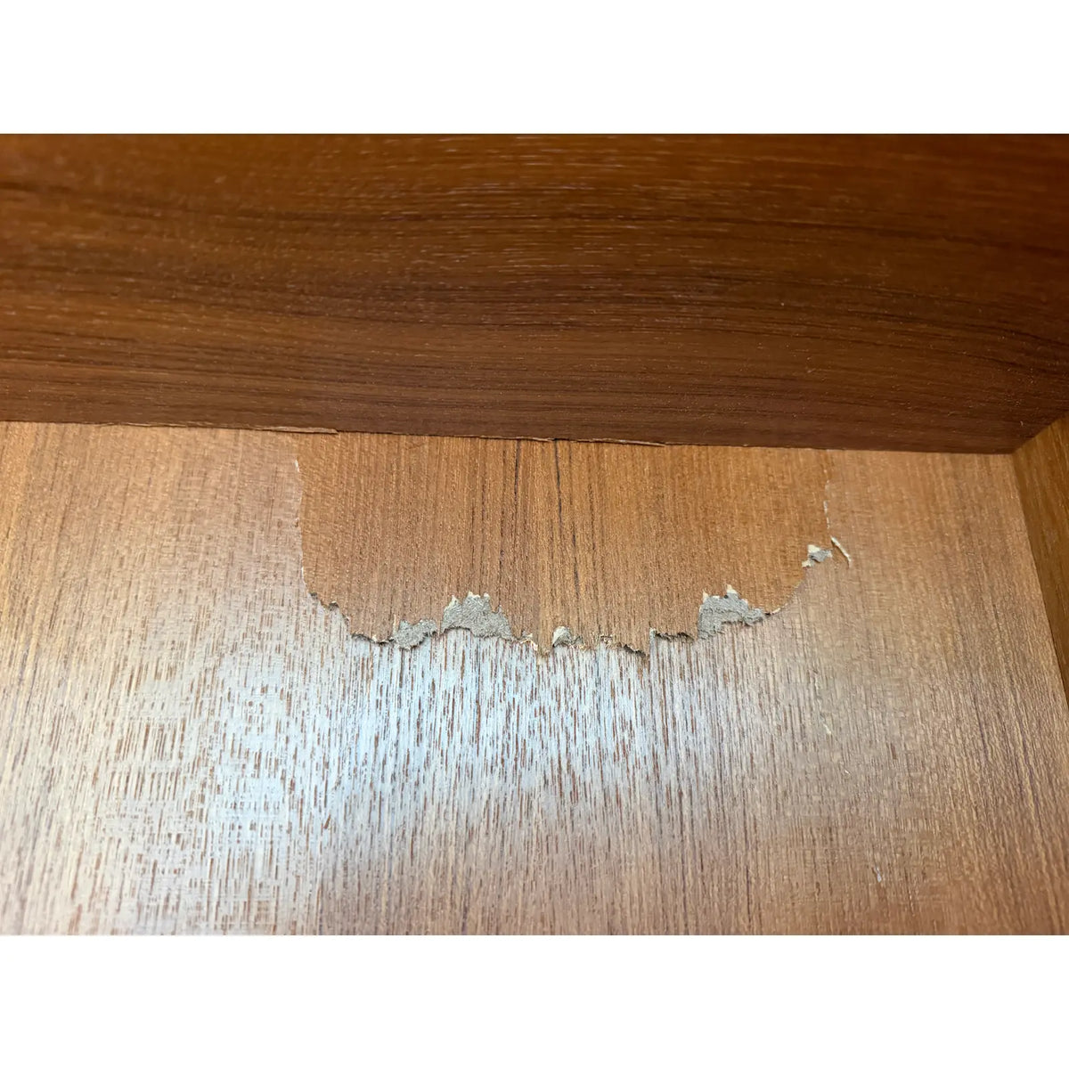 Hundevad teak wall unit with secretary, area of surface-layer loss on an upper backing panel